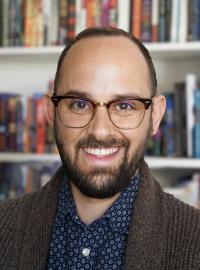 Photo of current DSC director, Peter Kvam, in front of a bookcase